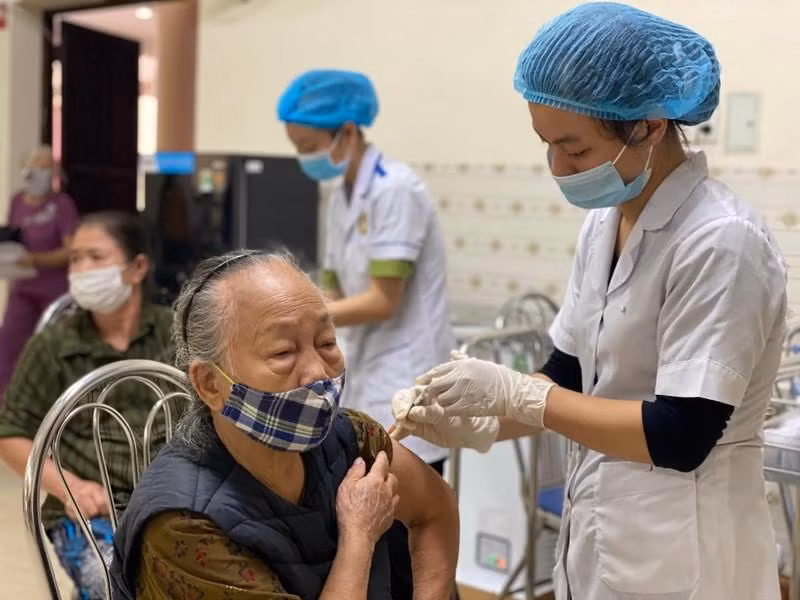 An old woman is vaccinated against COVID-19.