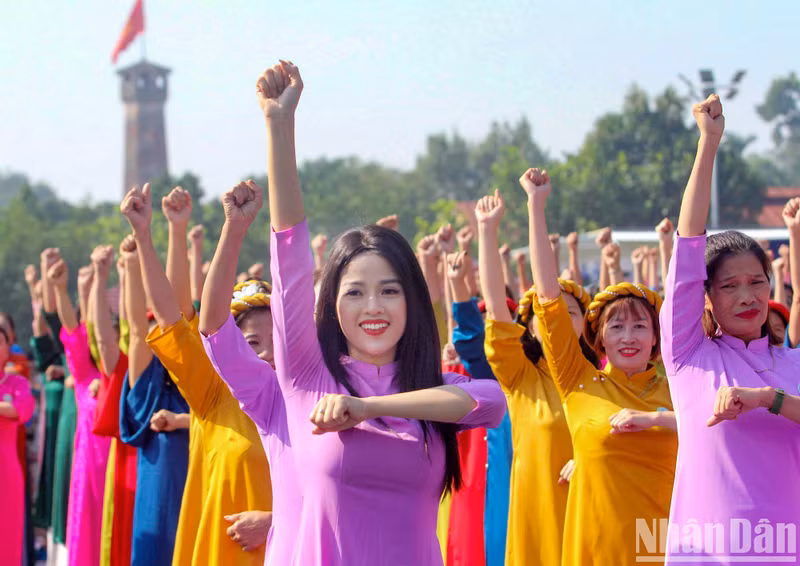 Women in ao dai perform against the background of songs about Hanoi.