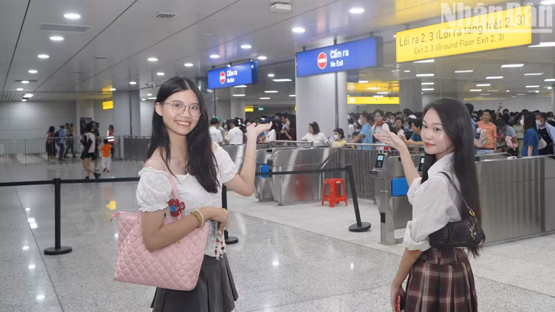Young girls pose for photos inside a metro station. Young girls pose for photos inside a metro station.