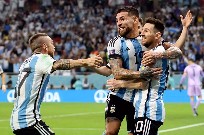 Argentina's Lionel Messi celebrates scoring their first goal against Australia with Nicolas Otamendi and Alejandro Gomez. REUTERS/Carl Recine