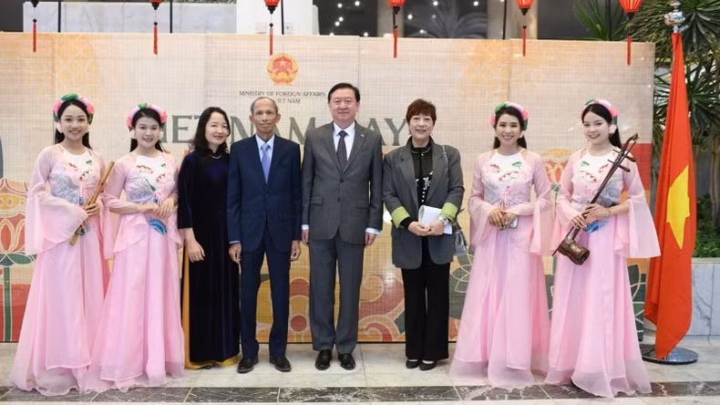 The Vietnamese Ambassador and his spouse, along with the Chinese Ambassador and his spouse, take a photo with traditional music artists.