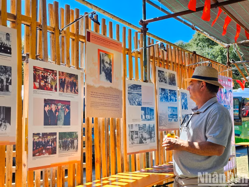 International friends spend considerable time viewing the images and famous quotes of President Ho Chi Minh.
