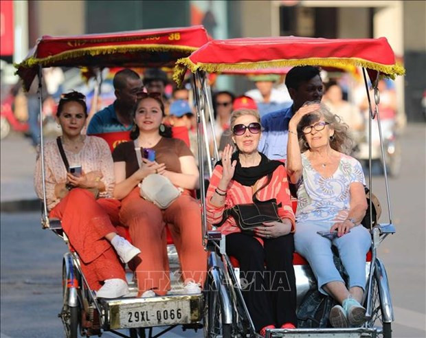 Foreign tourists on cyclos touring the Old Quarter, Hoan Kiem Lake, downtown Hanoi. (Photo: VNA)