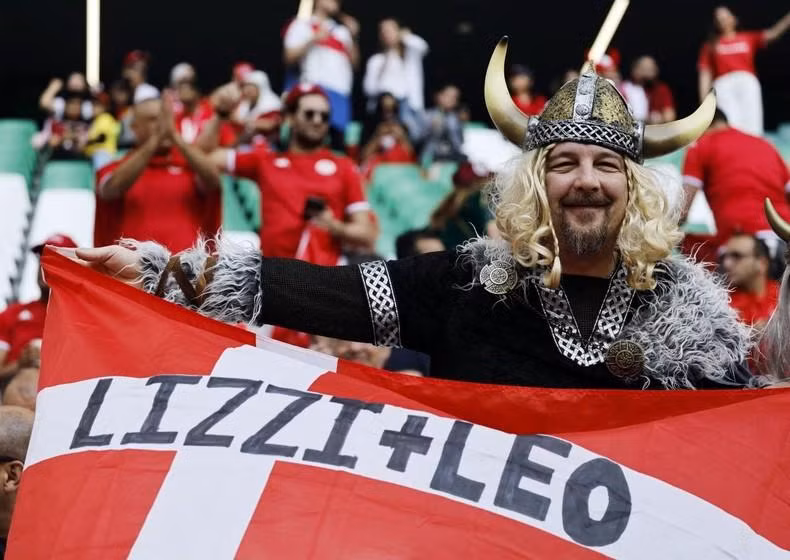 A Denmark fan displays a flag before their match against Tunisia. (Photo: Reuters)