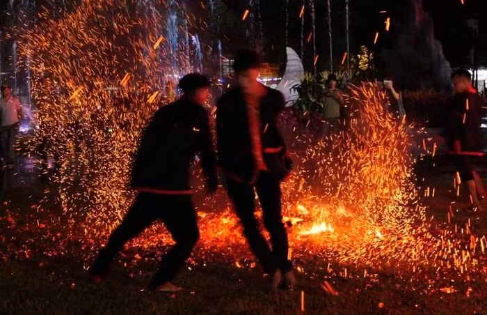 Pa Then men jump into the live coals.