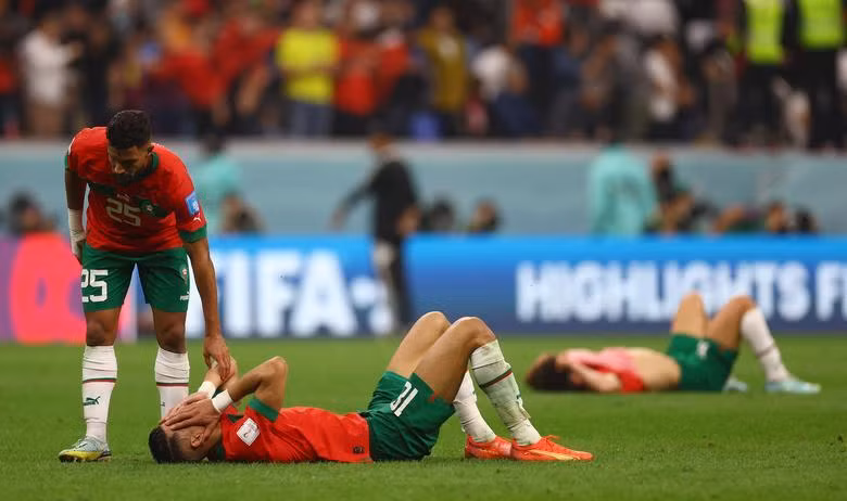Morocco's Yahya Attiat-Allah comforts Jawad El Yamiq after the match as Morocco are eliminated from the World Cup. (Photo: REUTERS)