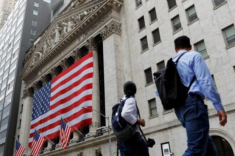 People walk by the New York Stock Exchange (NYSE) in Manhattan, New York City, the US. (Photo: Reuters)