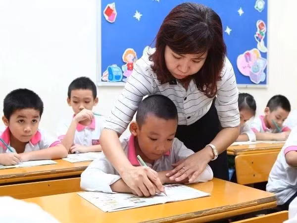 Students from kindergarten to high school in the public school system nationwide will be exempt from tuition fees from the start of the next school year. (Photo: VNA) 