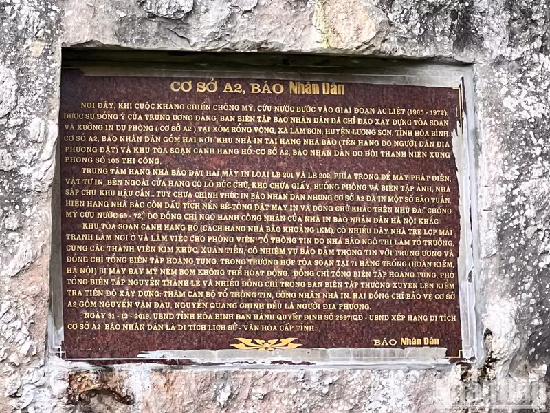 A plaque reading “Base A2, Nhan Dan Newspaper” outside the entrance of the Journalist Cave