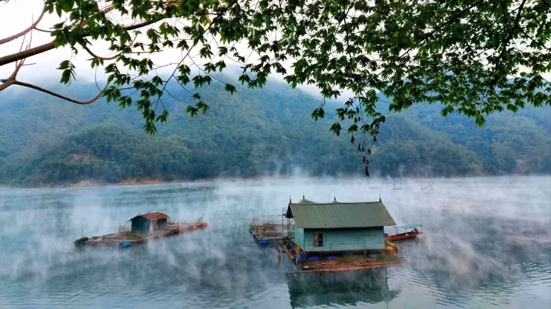 Floating fish farms amidst the poetic spring landscape.