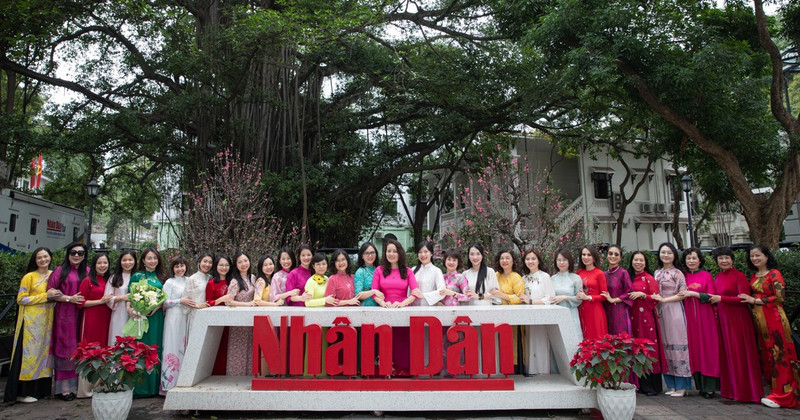 Female staff of Nhan Dan Newspaper embrace Ao Dai Week.