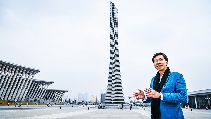 Architect Trinh Viet A beside the monumental structure designed by him and his colleagues.