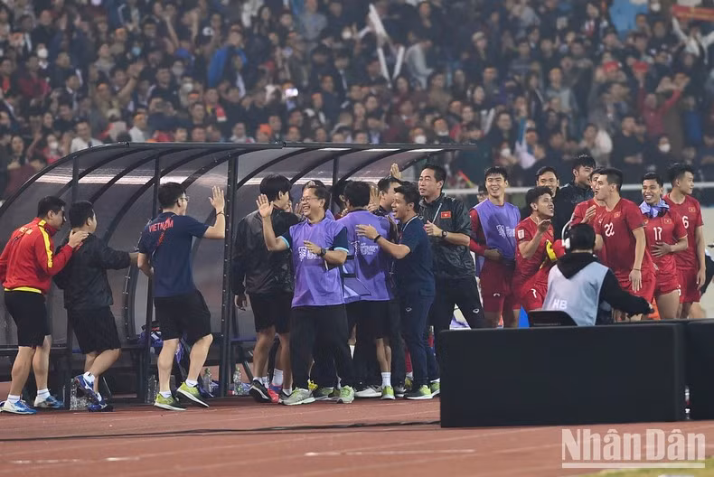 The coaching staff celebrates the important victory.
