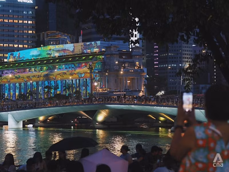 Before the transition to the New Year, a drizzle appeared in Marina Bay of Singapore. However, people still flocked to the area to enjoy a vibrant year-end night. (Photo: CNA)