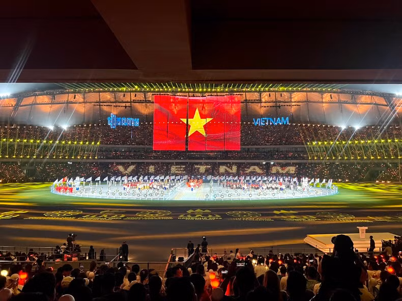 The organising committee uses a modern projection screen to show the national flags of the countries.