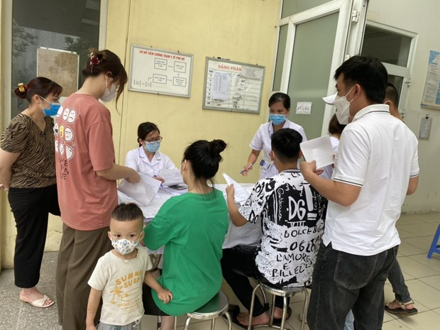 People register for COVID-19 vaccination at a health station in Hanoi. (Photo: VNA)