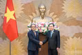 Chairman of the National Assembly Tran Thanh Man (right) receives Attorney General of Malaysia Tan Sri Mohd Dusuki Mokhtar in Ha Noi on July 7. (Photo: Duy Linh)