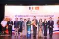 Leaders of HUFO and IDECAF present flowers to congratulate Etienne Ranaivoson, Consul General of France in Ho Chi Minh City, on the country's Bastille Day. (Photo: VNA) 