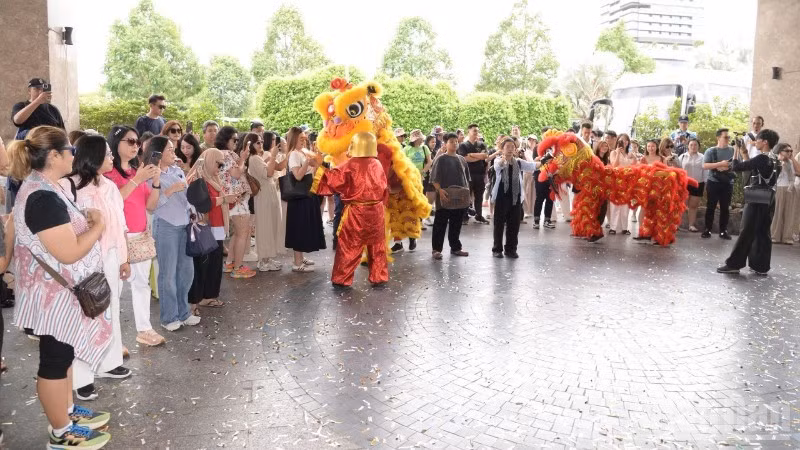 Indonesian tourists enjoy a traditional lion dance performance at My Tho Marina.
