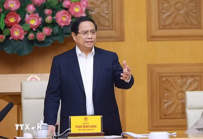 Prime Minister Pham Minh Chinh speaks at a meeting on accelerating Quang Trung Campaign. (Photo: VNA)