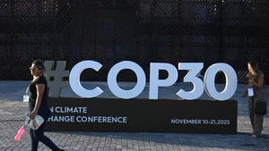 A woman walks past a logo of the upcoming 30th UN Climate Change Conference (COP30) in Belem, Brazil, Nov. 4, 2025. The COP30 will take place in the Amazon city of Belem from Nov. 10 to 21. (Photo: Xinhua).