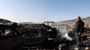 A Palestinian checks a vehicle scrapyard after Israeli settlers burned it in the town of Huwara, south of the West Bank city of Nablus, on Nov. 21, 2025. According to the official WAFA news agency, Israeli settlers set fire to a vehicle scrapyard here on Friday evening. (Photo: Xinhua)