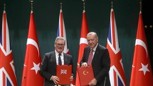 Turkish President Recep Tayyip Erdogan (R) and British Prime Minister Keir Starmer display the signed agreement in Ankara, Türkiye, Oct. 27, 2025. Türkiye signed a deal on Monday to buy 20 Eurofighter Typhoon fighter jets from Britain for 8 billion pounds (10.64 billion USD), as Ankara seeks to bolster its defense capabilities amid a turbulent regional landscape. (Mustafa Kaya/Handout via Xinhua)