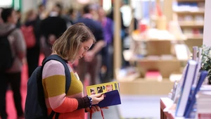 A woman visits the Frankfurt Book Fair in Frankfurt, Germany, Oct. 16, 2025. The world's largest book fair, the Frankfurt Book Fair, opened here on Tuesday with a focus on licensing and rights exchange. More than 4,000 publishers from over 90 countries and regions are present at the 77th book fair and more than 200,000 visitors are expected, said Juergen Boos, director of the Fair, at the opening ceremony. (Photo: Xinhua)