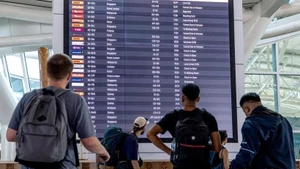 Passengers check information screens at I Gusti Ngurah Rai International Airport in Bali, Indonesia. (Photo: XINHUA)
