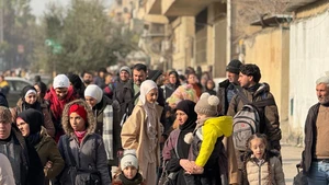 This photo taken with a mobile phone shows civilians leaving areas in the Sheikh Maqsoud and Ashrafieh neighborhoods in Aleppo city, northern Syria, on Jan. 7, 2026. Crowds of residents were forced to flee the predominantly Kurdish neighborhoods of Sheikh Maqsoud and Ashrafieh in the northern city of Aleppo on Wednesday, as clashes flared between the Syrian army and the Kurdish-led Syrian Democratic Forces (SDF). (Str/Xinhua)