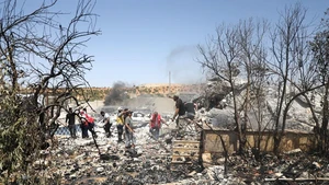 Rescue workers and residents search through the rubble following an explosion in Idlib, Syria, Aug. 14, 2025. A powerful explosion shook the countryside of Syria's Idlib province on Thursday, killing at least four people and injuring five others, according to Syrian state media and a war monitoring group. (Str/Xinhua)