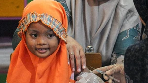 A girl smiles before receiving a dose of measles vaccine in Sumenep Regency, East Java, Indonesia, on Aug. 27, 2025. Indonesia has recorded 46 measles cases across 42 districts and cities in 13 provinces, with Sumenep in East Java identified as the worst-affected area with 17 deaths, the Ministry of Health said on Tuesday. (Photo: Xinhua)