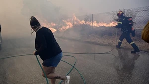 People battle the flames in Keratea, Greece, on Aug. 8, 2025. A large wildfire broke out Friday afternoon in Keratea, about 35 kilometers southeast of central Athens, forcing evacuations and triggering an emergency response. (Photo: Xinhua)