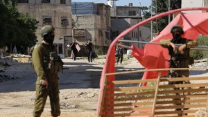 Displaced Palestinians carrying their belongings are seen in Tulkarm refugee camp, northern West Bank, on July 6, 2025. Displaced Palestinians were allowed to return for belongings after the Israeli army announced the demolition of houses here. (Photo: Xinhua)