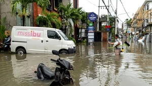 A man stands in flood water after heavy rain hit Canggu in Badung regency, Bali, Indonesia, on Sept. 15, 2025. (Photo: Xinhua)
