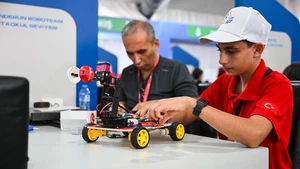 A participant adjusts a robot at the technology event TEKNOFEST in Istanbul, Türkiye, Sept. 17, 2025. The five-day event kicked off here on Wednesday, showcasing sci-tech advancements in fields such as aerospace, education and healthcare. (Photo: Xinhua)