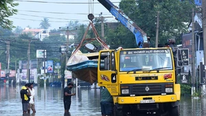 A rescue boat is transported by a crane truck through a flooded street in Colombo, Sri Lanka, on Dec. 1, 2025. The death toll from extreme weather conditions hitting Sri Lanka has risen to 410, while 336 people remain missing, the country's Disaster Management Center said Tuesday. (Photo: Xinhua)