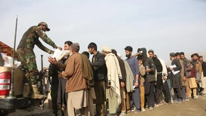 Afghan returnees receive food at a temporary camp at the Torkham border crossing, Afghanistan, Dec. 16, 2025. As the world marks International Migrants Day on Thursday, the unfolding narrative in Afghanistan is one of resilience and uncertainty. The forced return of thousands from neighboring countries is reshaping lives: many families are coming back to a homeland they barely know, striving to rebuild amid fragile security and limited support. (Photo: Xinhua)