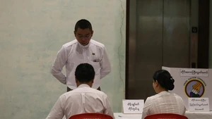 A voter checks in at a polling station in Yangon, Myanmar, Dec. 28, 2025. Myanmar kicked off its 2025 multi-party democratic general election with the first phase held on Sunday. The general election is scheduled to be held in three phases, with the second phase set for Jan. 11, 2026, followed by the third phase on Jan. 25. (Photo: Xinhua)