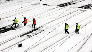 Workers clean snow at North Railway station in Bucharest, Romania, on Feb. 18, 2026. A heavy snowstorm hit southern and southeastern Romania overnight, prompting a red alert in Bucharest and disrupting road, air and maritime traffic, authorities said on Wednesday. (Photo: Xinhua)