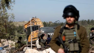Israeli soldiers are seen as an Israeli military excavator demolishes a Palestinian home in the town of Beit Awa, west of Hebron in the West Bank, on Feb. 5, 2026. (Photo: Xinhua)