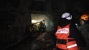 Emergency responders work at an impact site of an Iranian missile attack in Dimona, southern Israel, March 21, 2026. A missile fired from Iran injured 47 people in the southern Israeli city of Dimona on Saturday night, including a 10-year-old boy in serious condition, according to Israel's national emergency service Magen David Adom (MDA). (Israel Defense Forces/Handout via Xinhua)