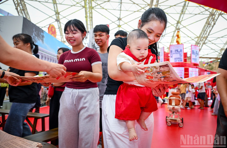 The joy of a young mother carrying her child while receiving this special publication.