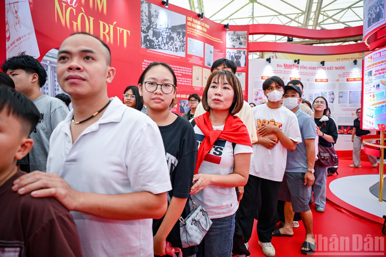 Everyone eagerly queued to receive the free Nhan Dan special supplement.