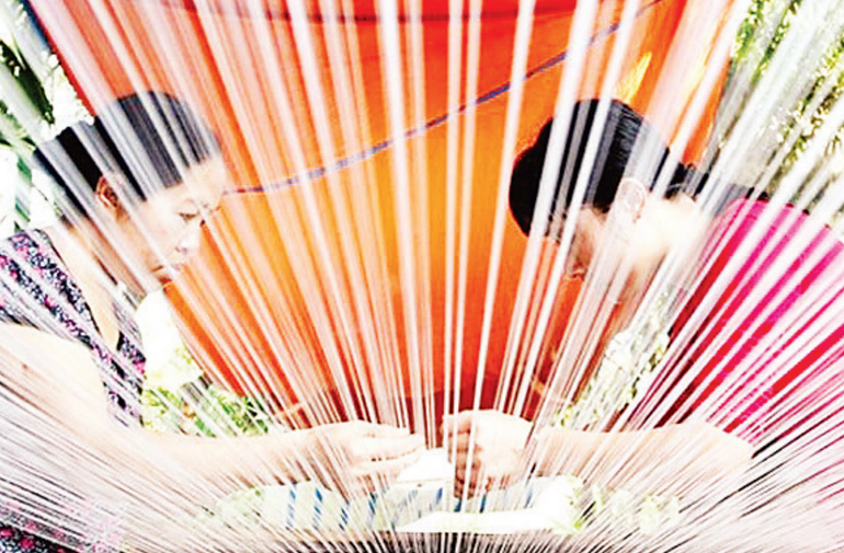 Nha Xa silk is woven from the meticulous and painstaking work of the weavers. Nha Xa silk is woven from the meticulous and painstaking work of the weavers.