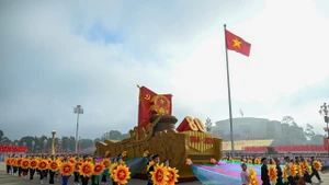 A float bearing the National Emblem of the Socialist Republic of Viet Nam leads the military parade and mass procession. (Photo: NDO)