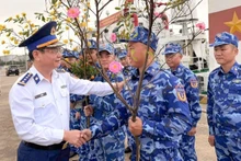 Colonel Le Huy, Political Commissar of Coast Guard Region 2, encourages officers and soldiers before they begin their Tet duty at sea.