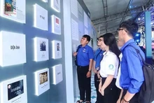 Visitors at the exhibition of 50 outstanding literary and artistic works, 50 exemplary construction projects/clusters, and 50 remarkable events and activities of Ho Chi Minh City. (Photo: Organising Committee)