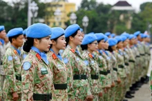 The “steel roses” of Viet Nam’s Peacekeeping Force report their achievements to Uncle Ho after successfully completing international missions in Africa. (Photo: NAM TRAN)