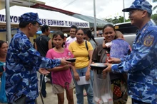 Vietnam Coast Guard officers directly deliver food portions to residents affected by the earthquake in Bogo Province, the Philippines.